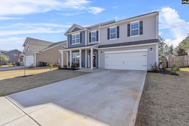 front of property featuring covered porch and a garage