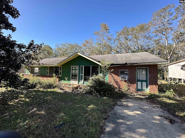 ranch-style home with a front lawn