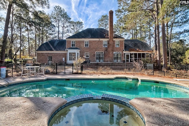 view of pool featuring an in ground hot tub