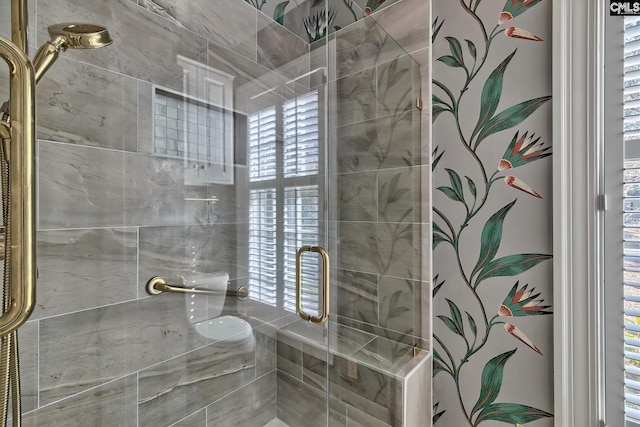 bathroom featuring a healthy amount of sunlight and walk in shower