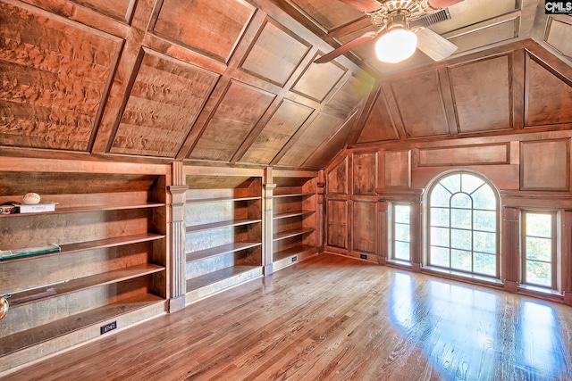 bonus room featuring lofted ceiling, wood walls, wood ceiling, built in features, and light hardwood / wood-style floors