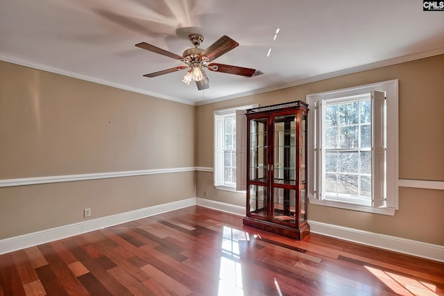 unfurnished room featuring wood-type flooring, ornamental molding, and ceiling fan