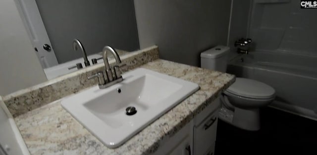 full bathroom featuring toilet, vanity, and shower / bathing tub combination