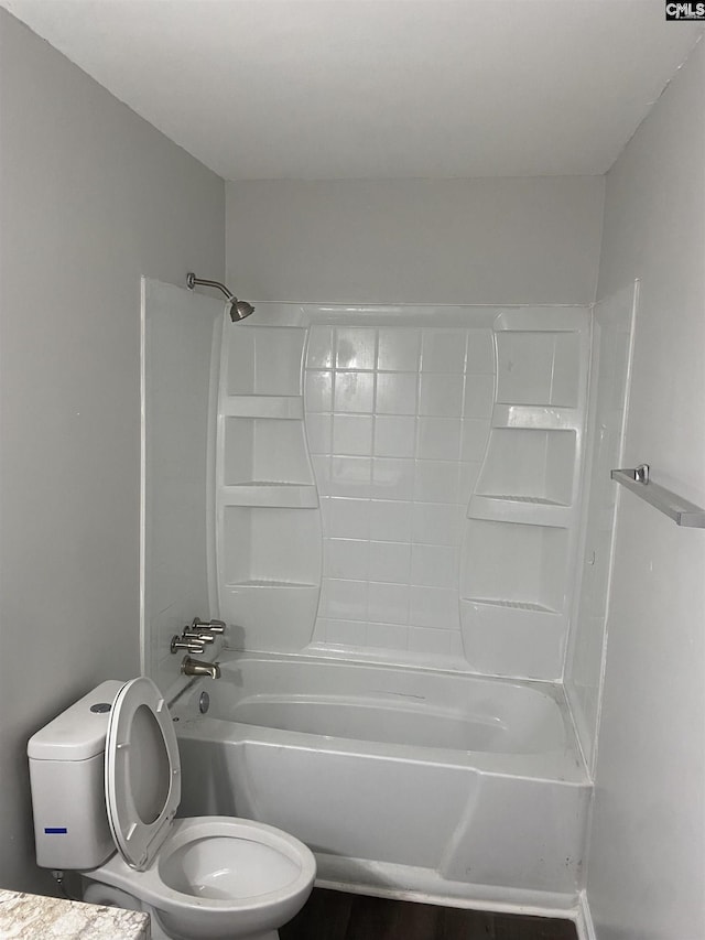 bathroom featuring tub / shower combination and toilet