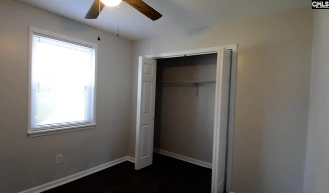 unfurnished bedroom featuring ceiling fan, a closet, and multiple windows