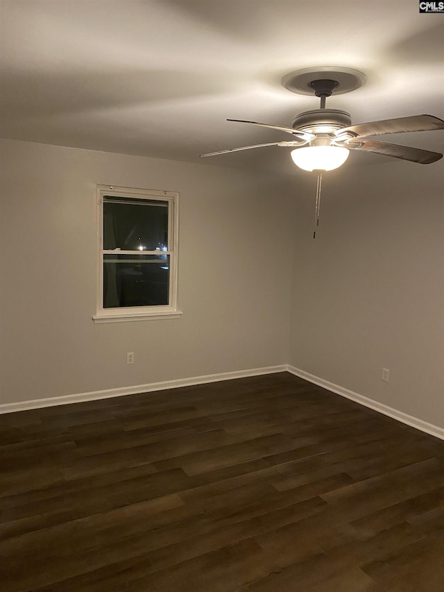 spare room with ceiling fan and dark hardwood / wood-style floors