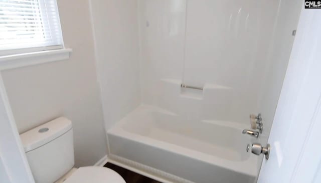 bathroom featuring toilet and shower / tub combination