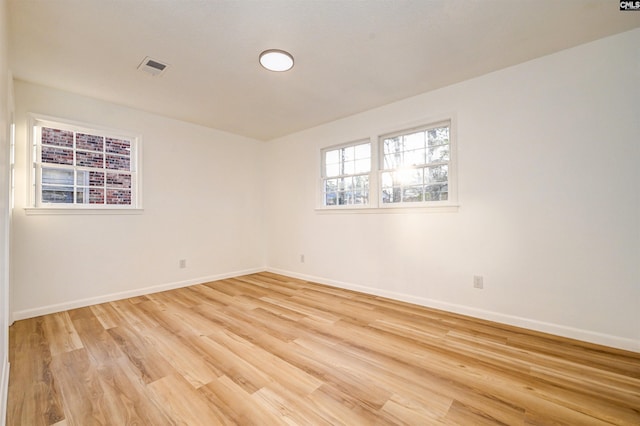 unfurnished room with light hardwood / wood-style flooring