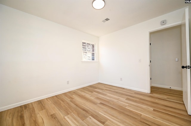 empty room with light hardwood / wood-style floors