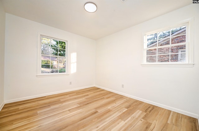 spare room featuring light wood-type flooring