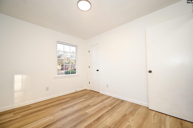 unfurnished room with light wood-type flooring