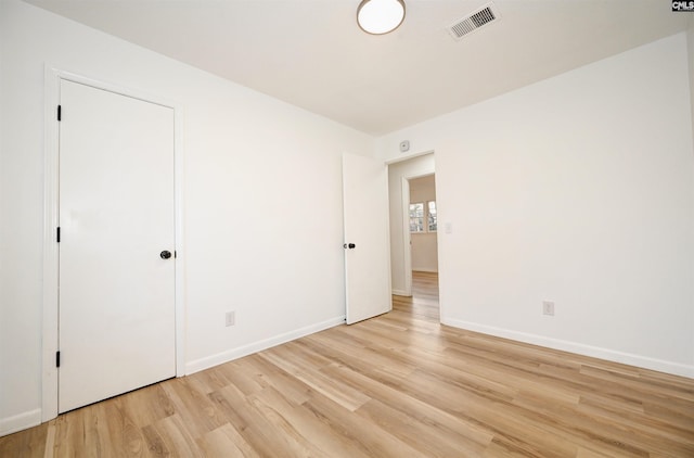 unfurnished bedroom with light wood-type flooring