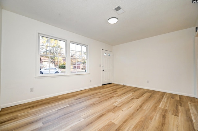 spare room with light wood-type flooring