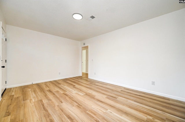 unfurnished room with light wood-type flooring