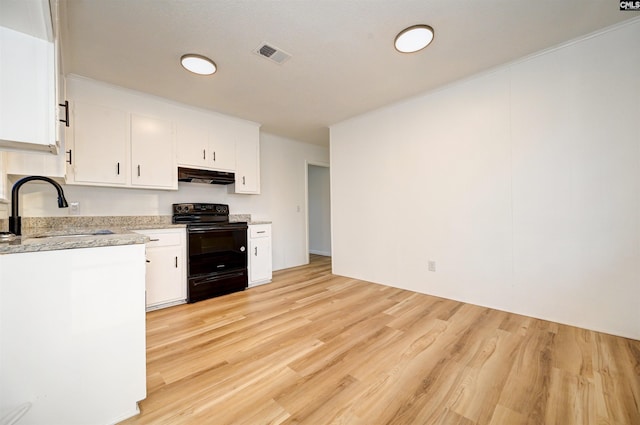 kitchen with light wood-type flooring, sink, white cabinets, and black / electric stove