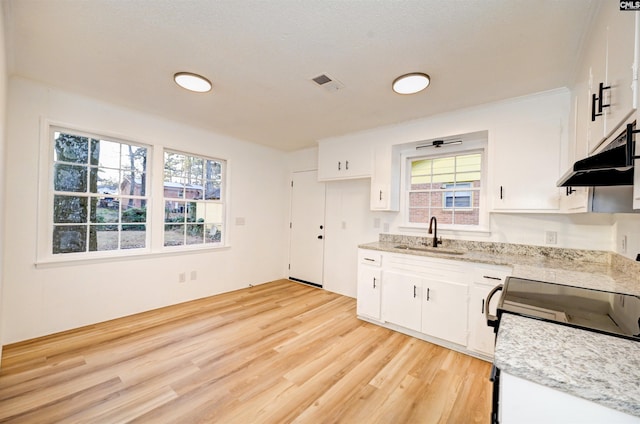 kitchen featuring sink, white cabinetry, and light hardwood / wood-style floors