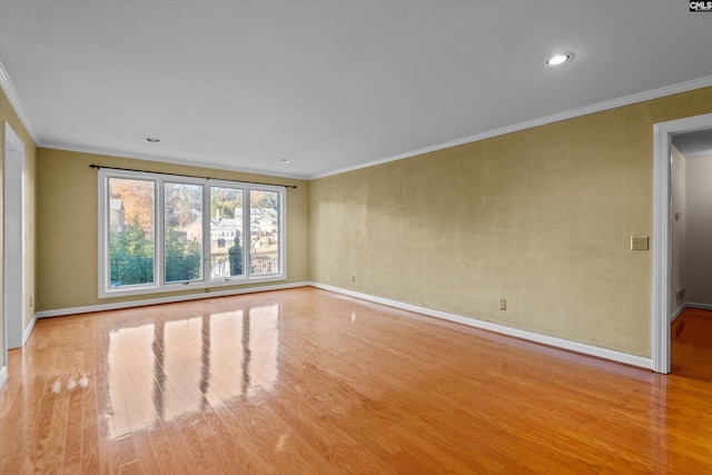 unfurnished room featuring ornamental molding and light hardwood / wood-style floors