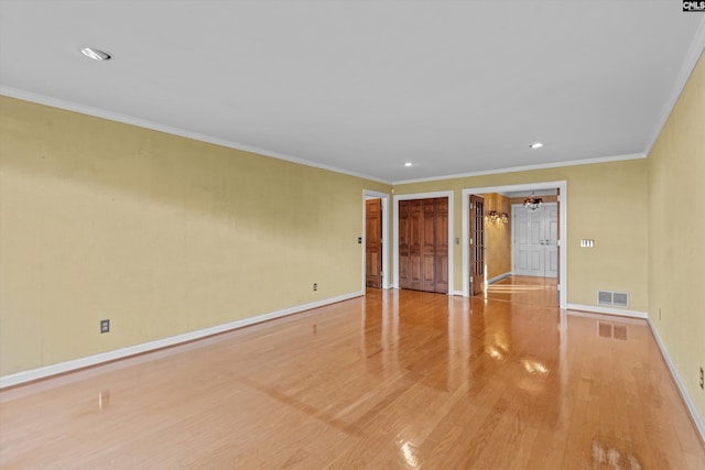 spare room with crown molding and light hardwood / wood-style floors