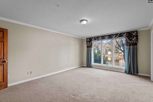 empty room with a textured ceiling, ornamental molding, and carpet flooring