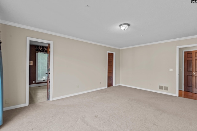 carpeted empty room with crown molding