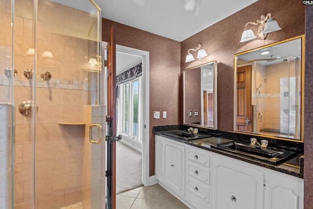 bathroom featuring walk in shower, vanity, and tile patterned flooring