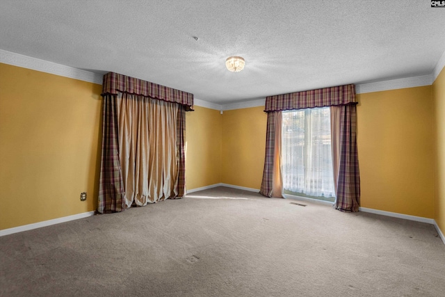 carpeted empty room with a textured ceiling and crown molding