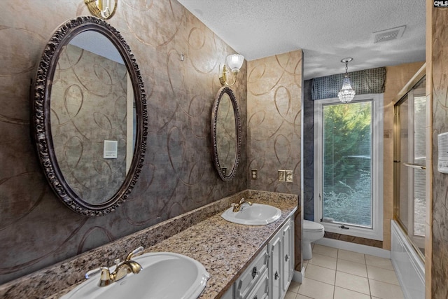 bathroom featuring a textured ceiling, toilet, tile patterned flooring, and plenty of natural light