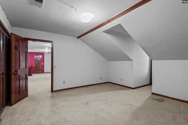 bonus room with light carpet and lofted ceiling