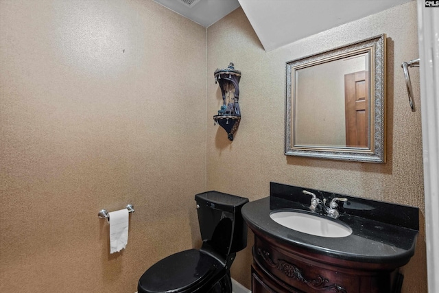 bathroom featuring toilet and vanity