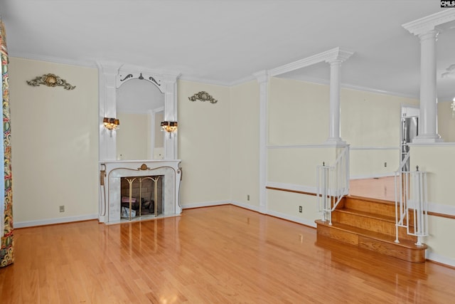 unfurnished living room featuring crown molding and hardwood / wood-style flooring