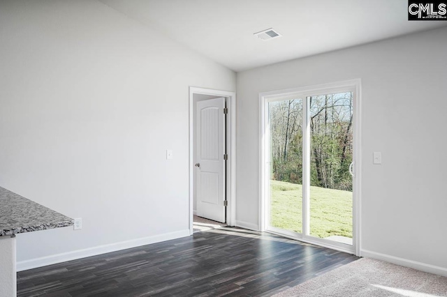 entryway featuring lofted ceiling and dark wood-type flooring