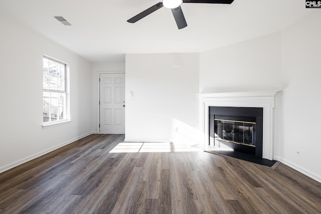 unfurnished living room with ceiling fan and dark hardwood / wood-style floors