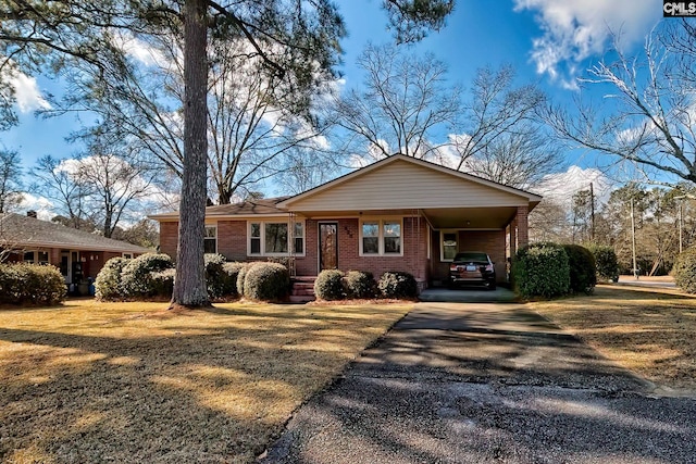 ranch-style home featuring a front yard and a carport