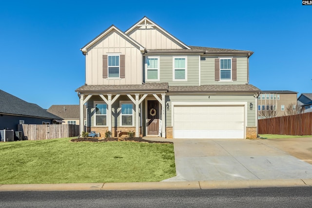 view of front of house with a front lawn, a porch, and a garage