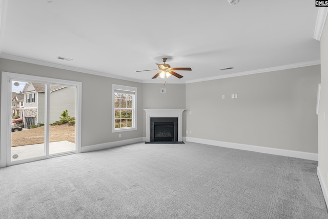 unfurnished living room with ceiling fan, carpet, and crown molding