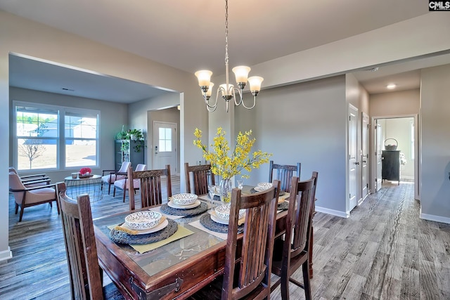 dining area with a chandelier and hardwood / wood-style flooring