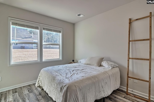 bedroom featuring dark hardwood / wood-style flooring