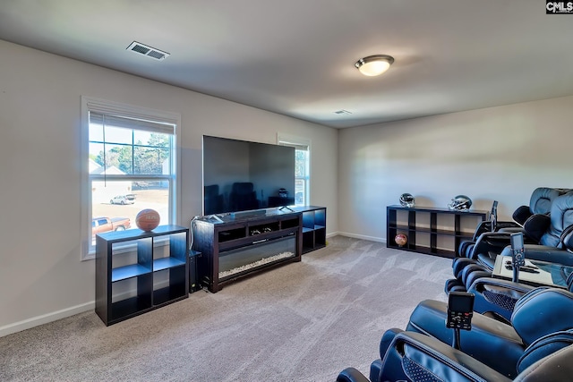 living room with plenty of natural light and light carpet