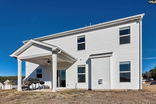 back of property featuring ceiling fan and a patio area