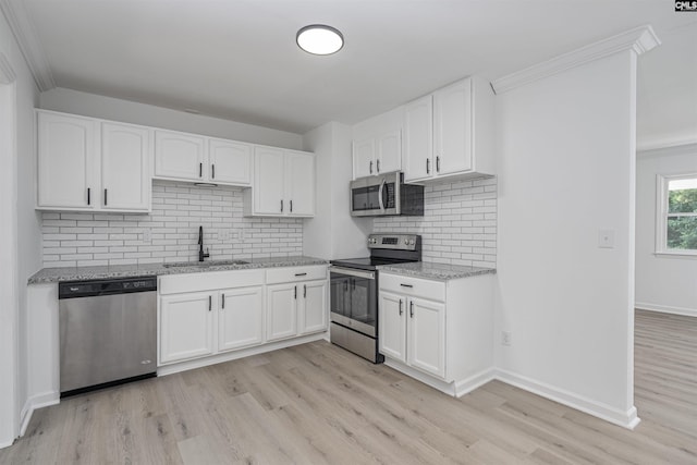 kitchen with sink, white cabinetry, and stainless steel appliances