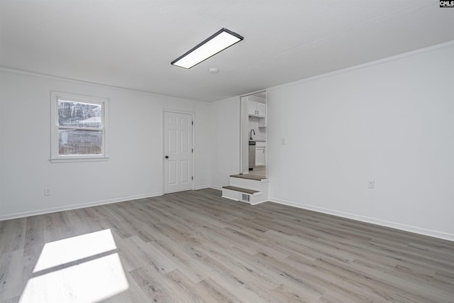 interior space featuring light hardwood / wood-style floors, sink, and crown molding