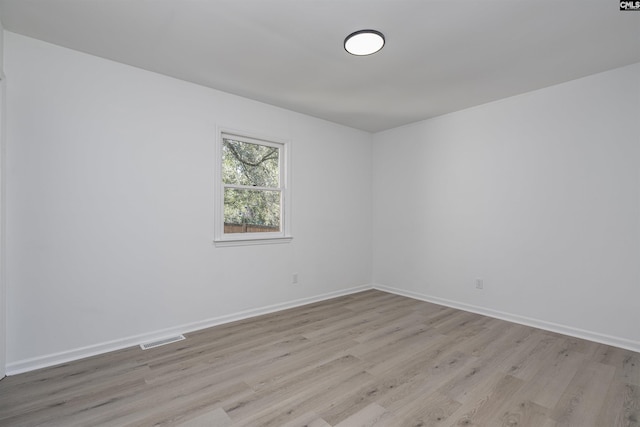 spare room with light hardwood / wood-style floors