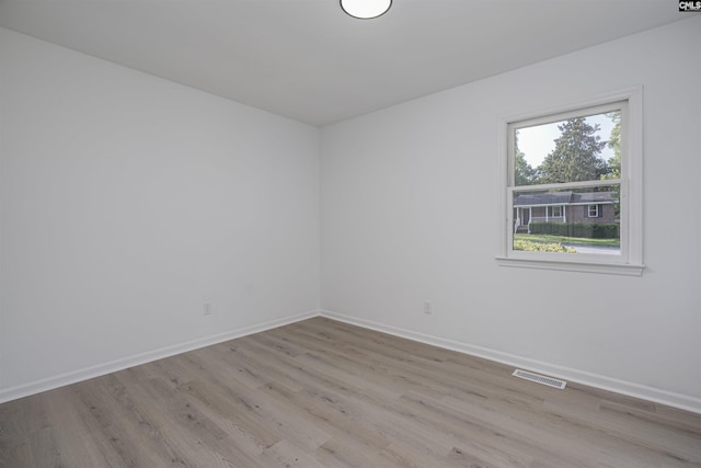 empty room with plenty of natural light and light wood-type flooring