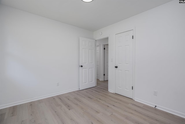 unfurnished room with light wood-type flooring