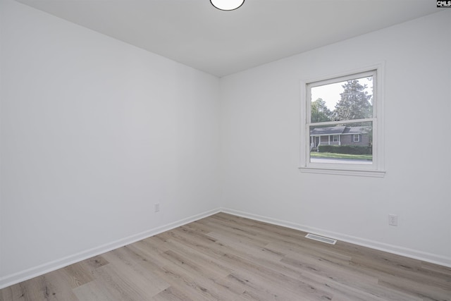 spare room with light hardwood / wood-style flooring