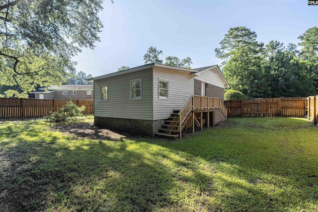 back of house with a lawn