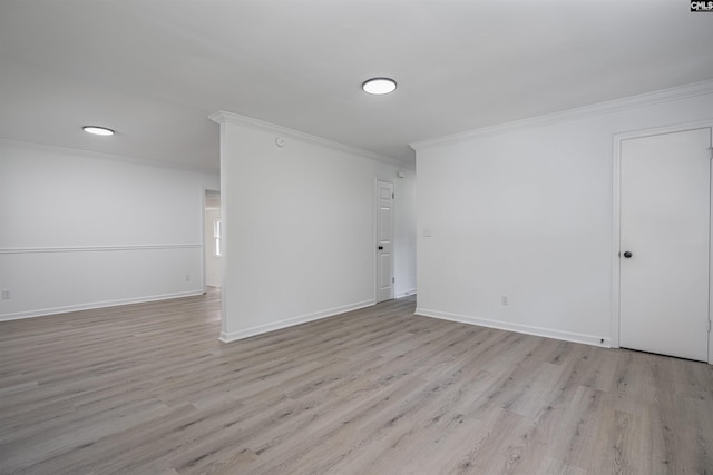 empty room featuring ornamental molding and light hardwood / wood-style floors