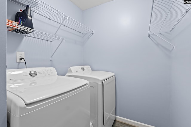 laundry room featuring hardwood / wood-style floors and washing machine and clothes dryer