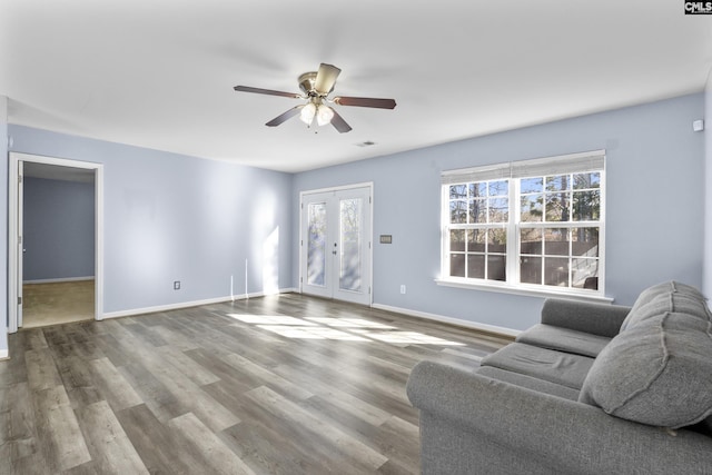 living room featuring ceiling fan, wood-type flooring, and french doors