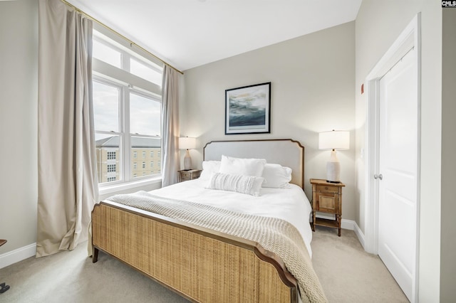 bedroom featuring light colored carpet